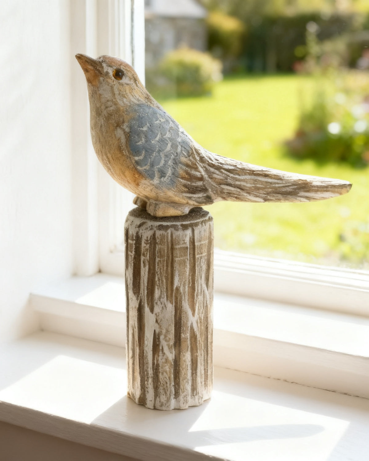 Hand-carved wooden songbird on a turned post